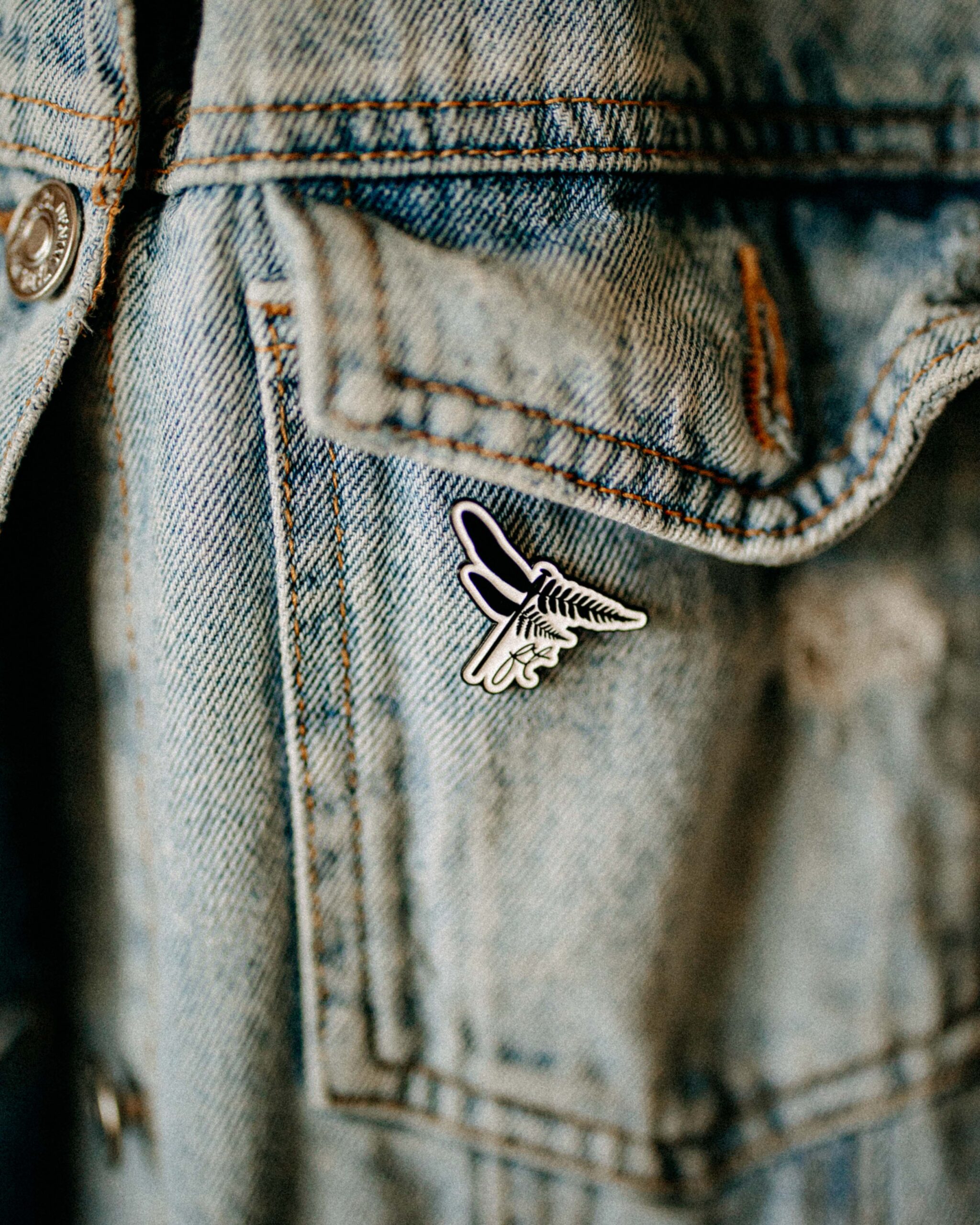 Ferny Pin attached to a denim jacket pocket.