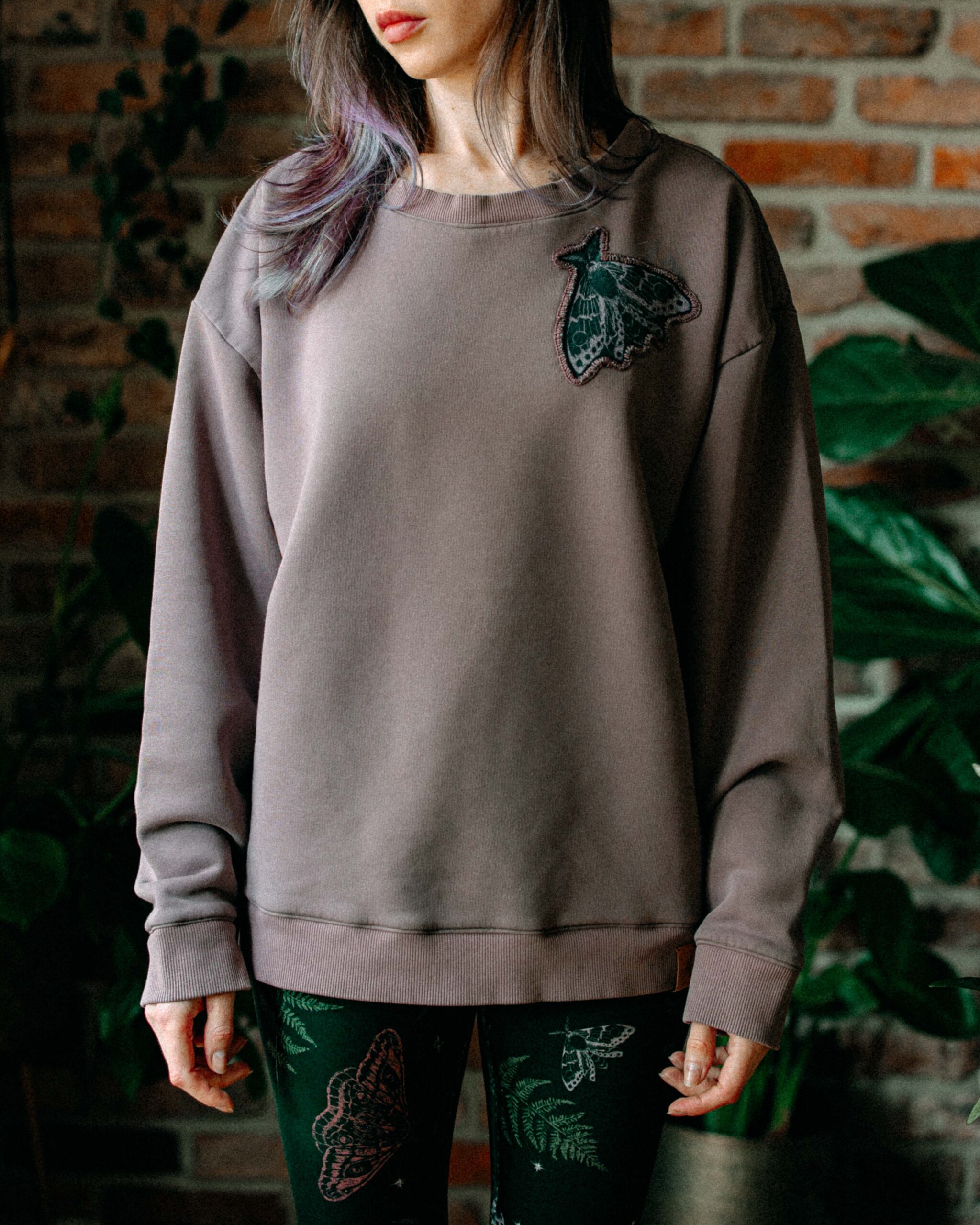 Model wearing the full Moorlands Moth Sweatshirt in muted mauve-grey.